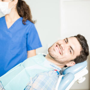 imagem de paciente homem sentado na cadeira pelo dentista na clínica